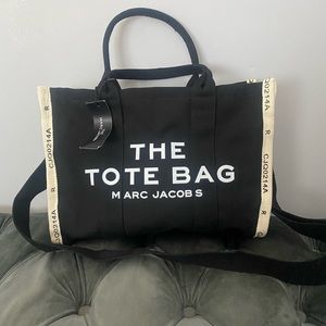 black tote bag with shoulder strap and beige trim